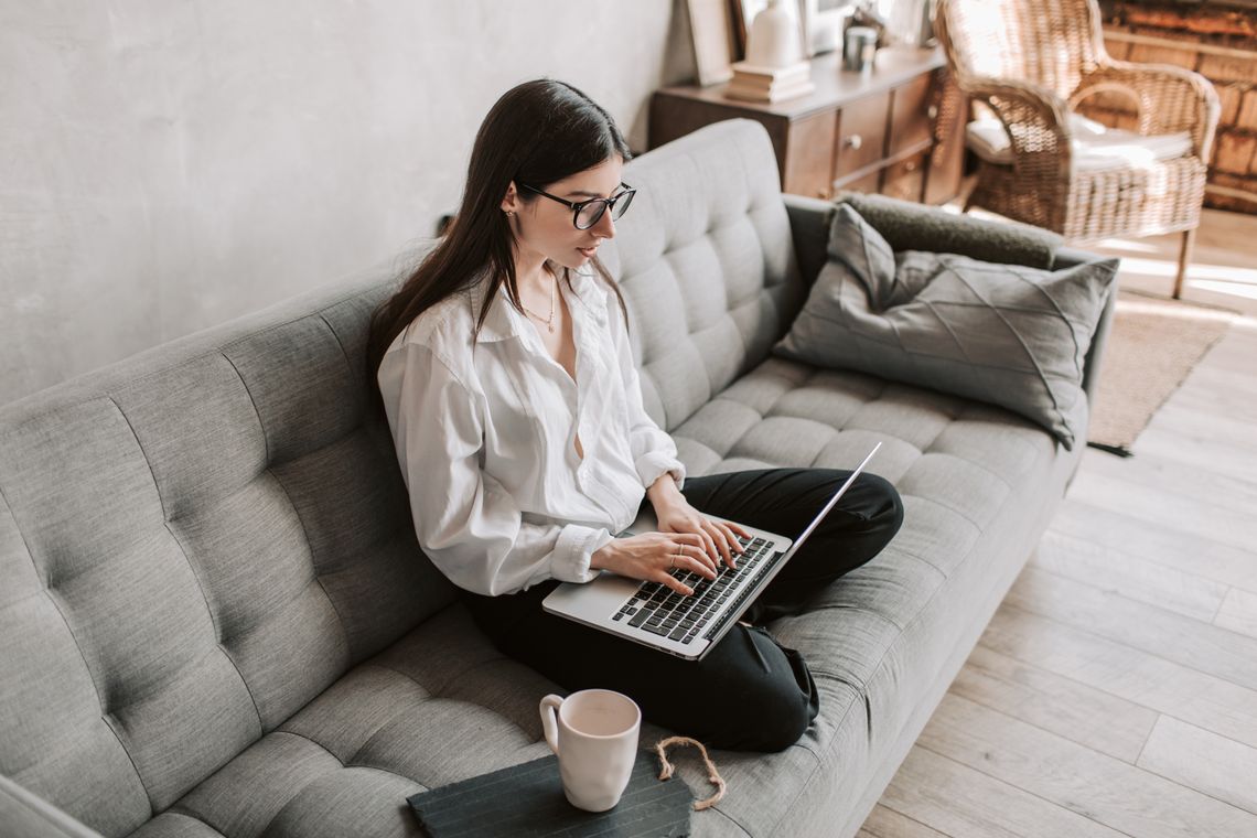 Creative workspace lifestyle founder reviewing beautiful art prints at home